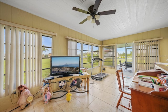 sunroom / solarium featuring a wealth of natural light and ceiling fan