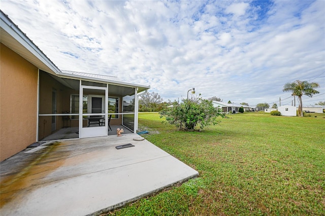 view of yard with a sunroom and a patio area