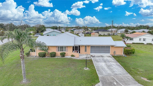 ranch-style home with a garage and a front lawn