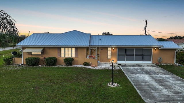 ranch-style home with a yard