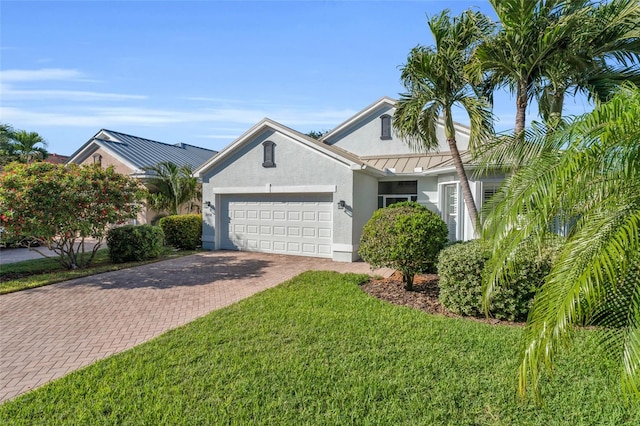 view of front of home featuring a garage and a front lawn