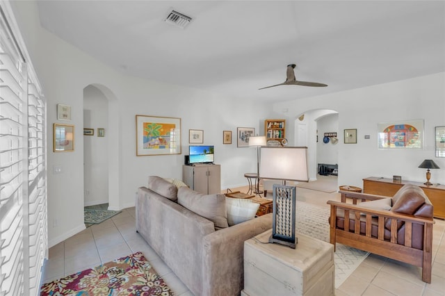 tiled living room featuring ceiling fan