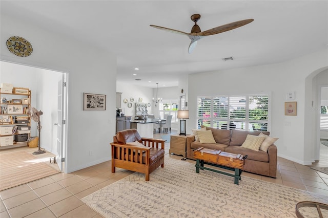 tiled living room with ceiling fan