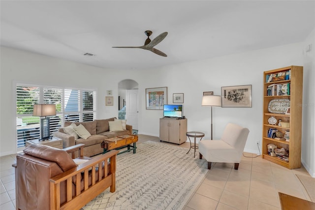 tiled living room with ceiling fan