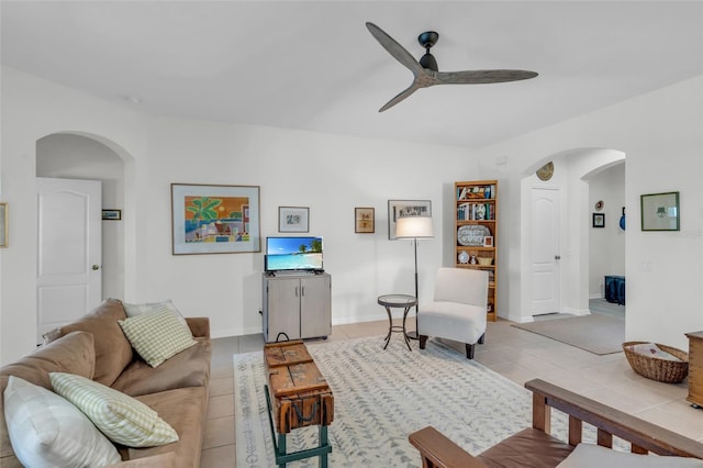 tiled living room with ceiling fan