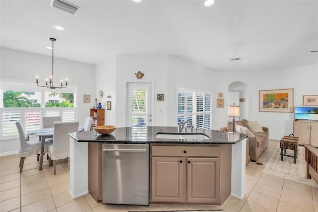 kitchen featuring dark stone counters, a chandelier, sink, and a healthy amount of sunlight