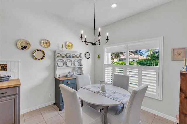 tiled dining space with a chandelier