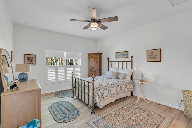 bedroom with light hardwood / wood-style flooring and ceiling fan