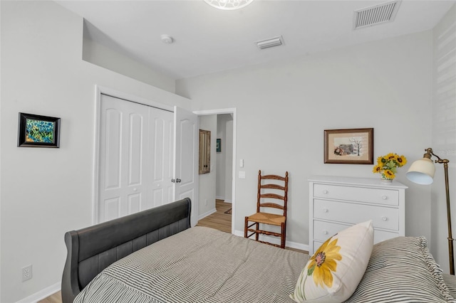 bedroom with a closet and light hardwood / wood-style flooring