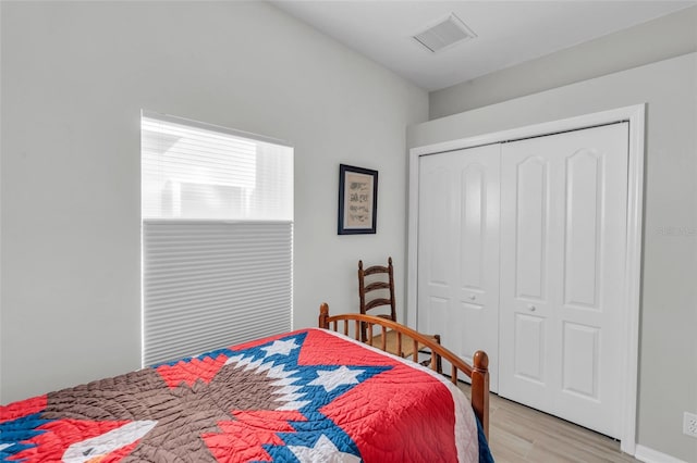 bedroom featuring light hardwood / wood-style flooring and a closet