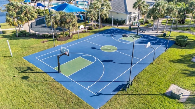 view of sport court with a yard