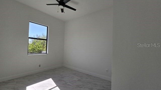 unfurnished room with ceiling fan