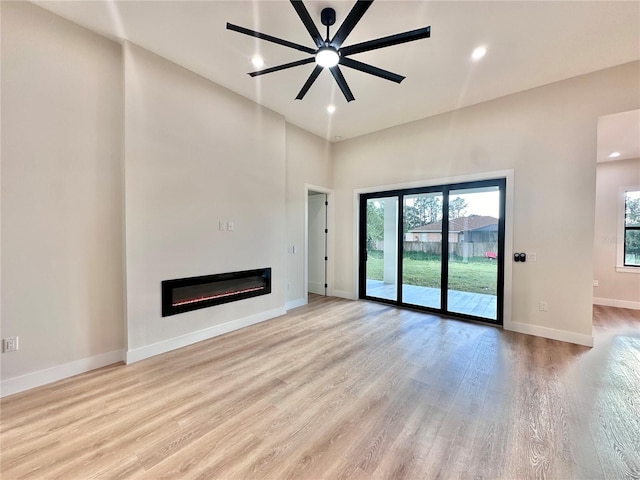 unfurnished living room with ceiling fan and light hardwood / wood-style flooring