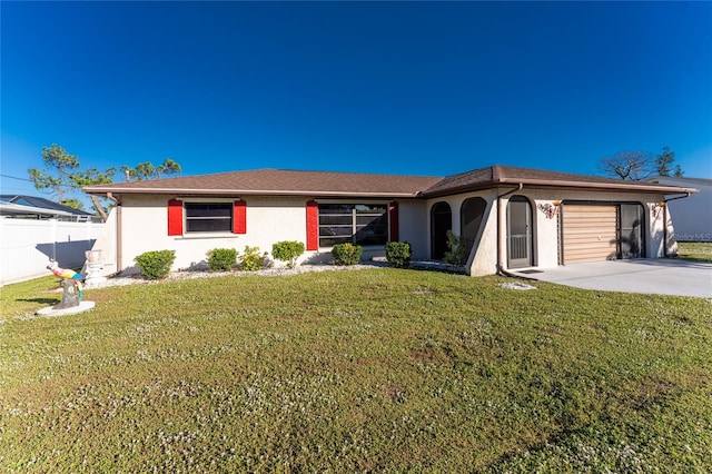 view of front of home featuring a garage and a front lawn