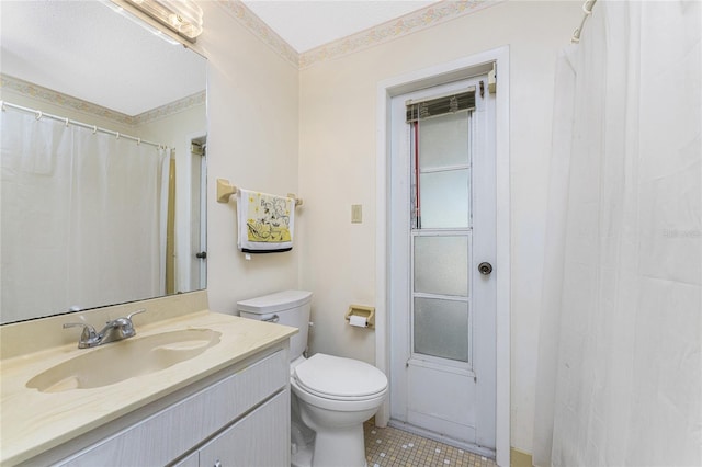 bathroom featuring tile patterned floors, vanity, and toilet