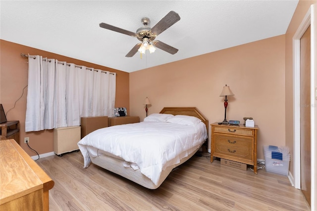 bedroom with light wood-type flooring and ceiling fan