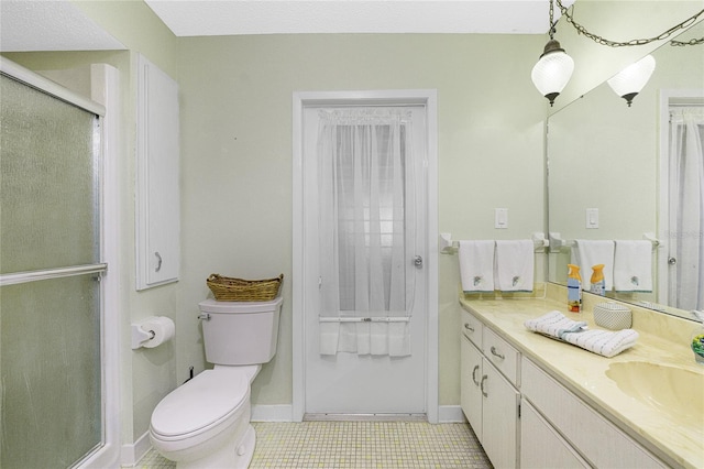 bathroom with tile patterned floors, a textured ceiling, vanity, toilet, and a shower with shower door