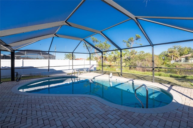 view of swimming pool with a patio and glass enclosure