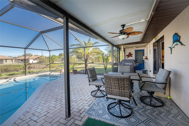 view of patio with glass enclosure and ceiling fan