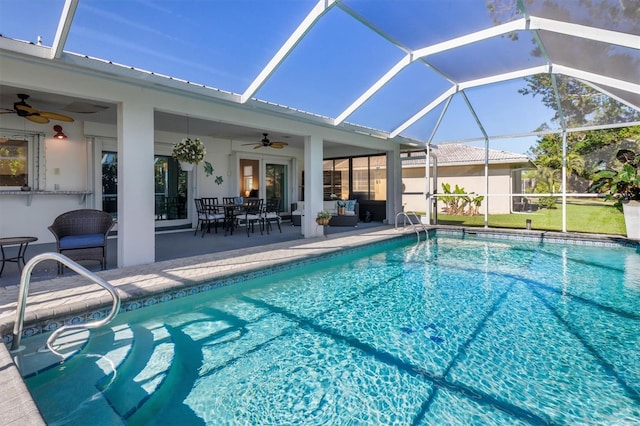 view of pool featuring a lanai, ceiling fan, and a patio area