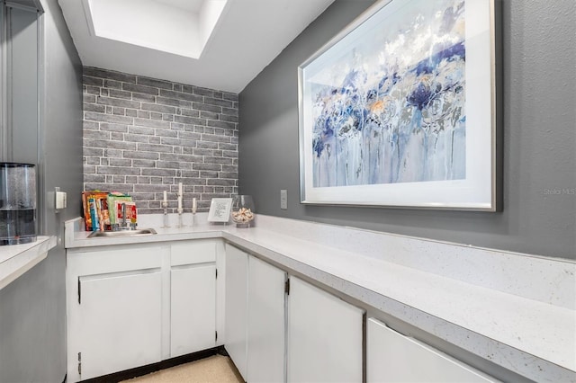 kitchen with white cabinetry and decorative backsplash