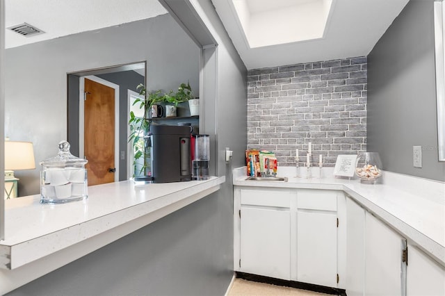 kitchen featuring backsplash and white cabinetry