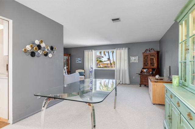 dining room with light carpet