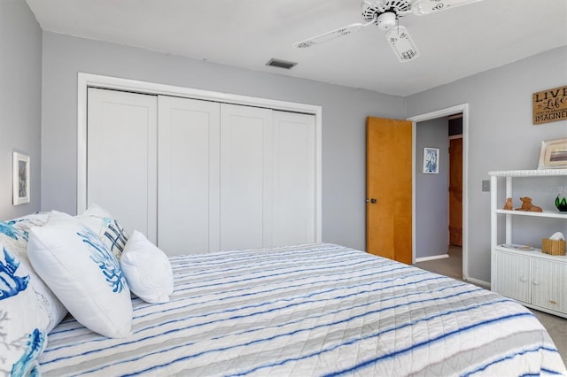 carpeted bedroom featuring a closet and ceiling fan