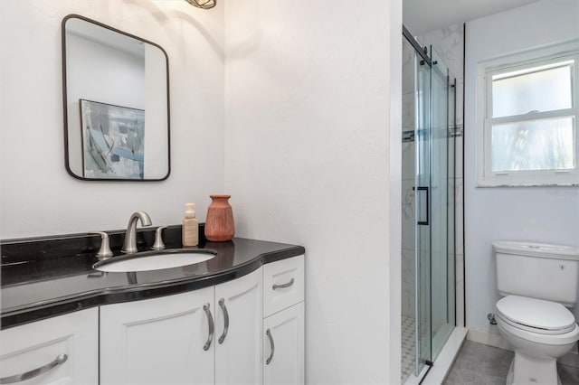 bathroom featuring tile patterned flooring, vanity, toilet, and an enclosed shower