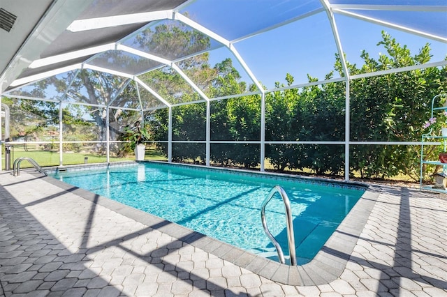 view of pool with a lanai and a patio area