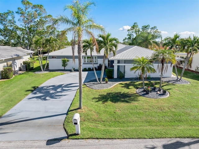 view of front of home featuring cooling unit and a front lawn