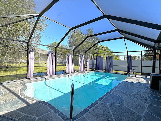 view of pool featuring a lanai, a yard, and a patio