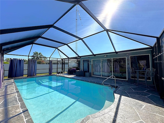 view of swimming pool with a lanai and a patio