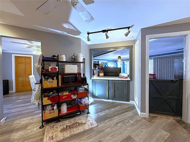 interior space featuring light wood-type flooring and lofted ceiling