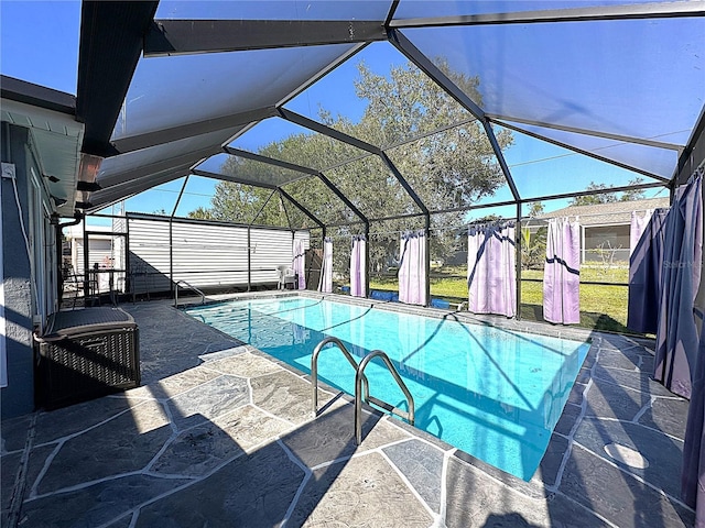 view of swimming pool with a patio area and glass enclosure