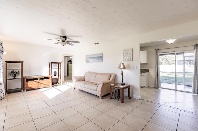 living room with ceiling fan and light tile patterned floors