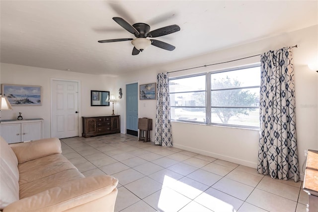 living room featuring ceiling fan and light tile patterned floors