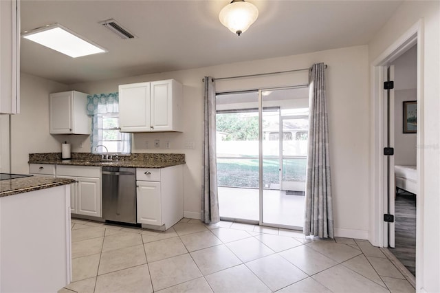 kitchen with white cabinets, dishwasher, a healthy amount of sunlight, and dark stone counters