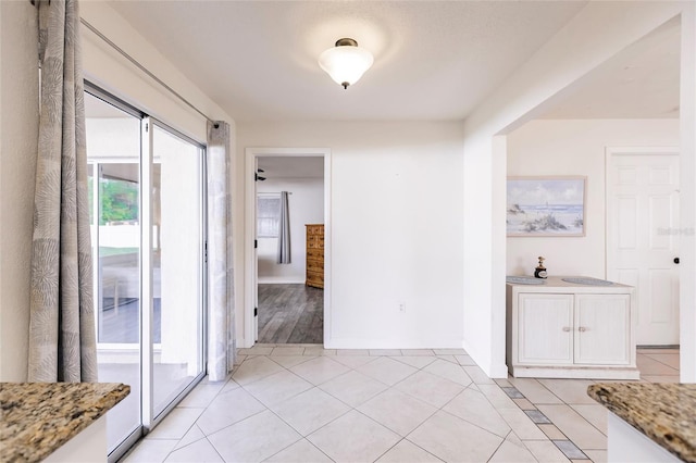 corridor with light tile patterned floors