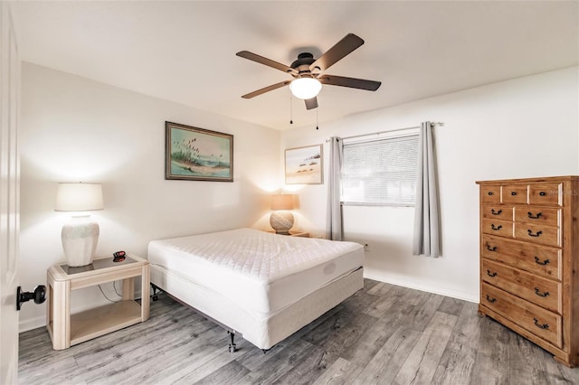 bedroom with ceiling fan and hardwood / wood-style floors