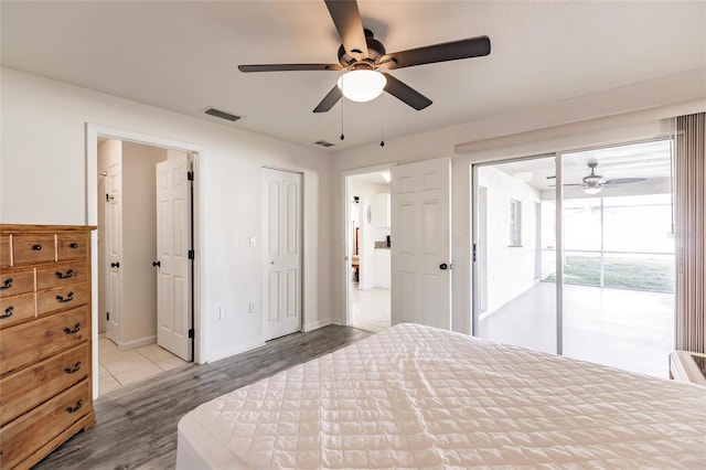 bedroom with hardwood / wood-style floors, ceiling fan, and access to outside