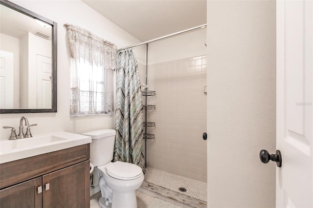 bathroom featuring a shower with curtain, vanity, toilet, and tile patterned flooring