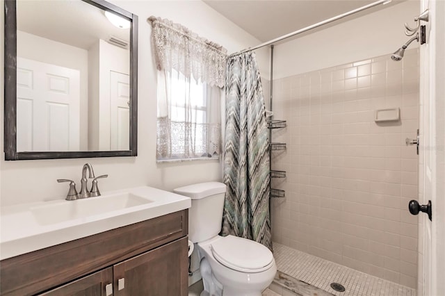 bathroom with vanity, toilet, and walk in shower