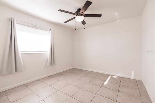 spare room featuring ceiling fan and light tile patterned flooring