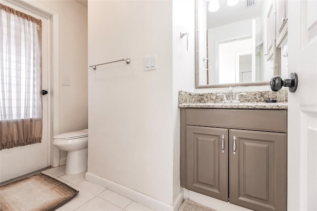 bathroom featuring tile patterned flooring, vanity, and toilet