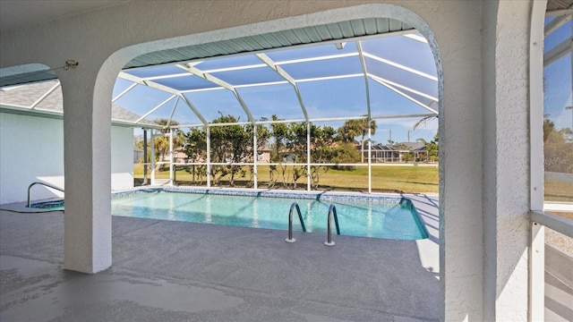 view of swimming pool with a lanai