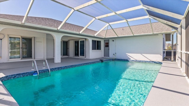 view of swimming pool with a patio and a lanai