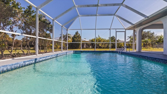 view of swimming pool featuring a lanai