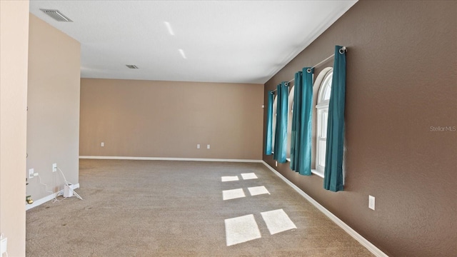 spare room with light colored carpet