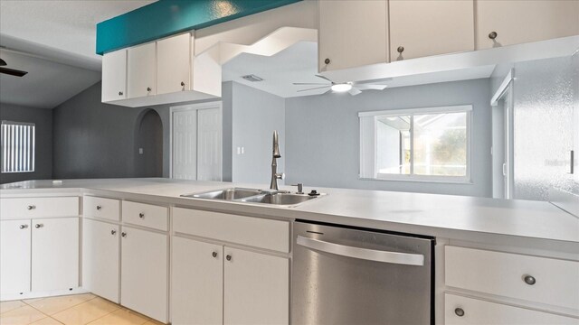 kitchen featuring ceiling fan, dishwasher, sink, light tile patterned floors, and white cabinets